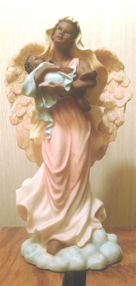 black angel figurines|black angel holding child.